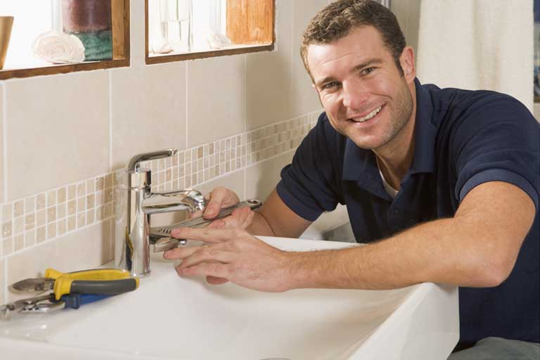 Plumber Installing New Bathroom Sink